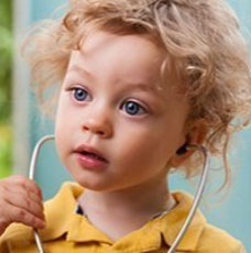 Toddler boy playing with a stethoscope