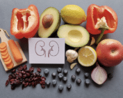 A variety of colorful fruits and vegetables, nuts, and whole grains displayed on a table, representing foods that are good for your kidneys.