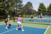 Adults playing on a pickleball court